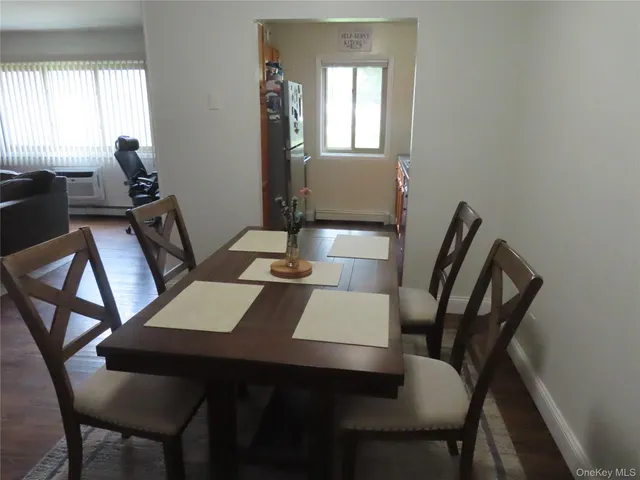 a view of a dining room with furniture and window