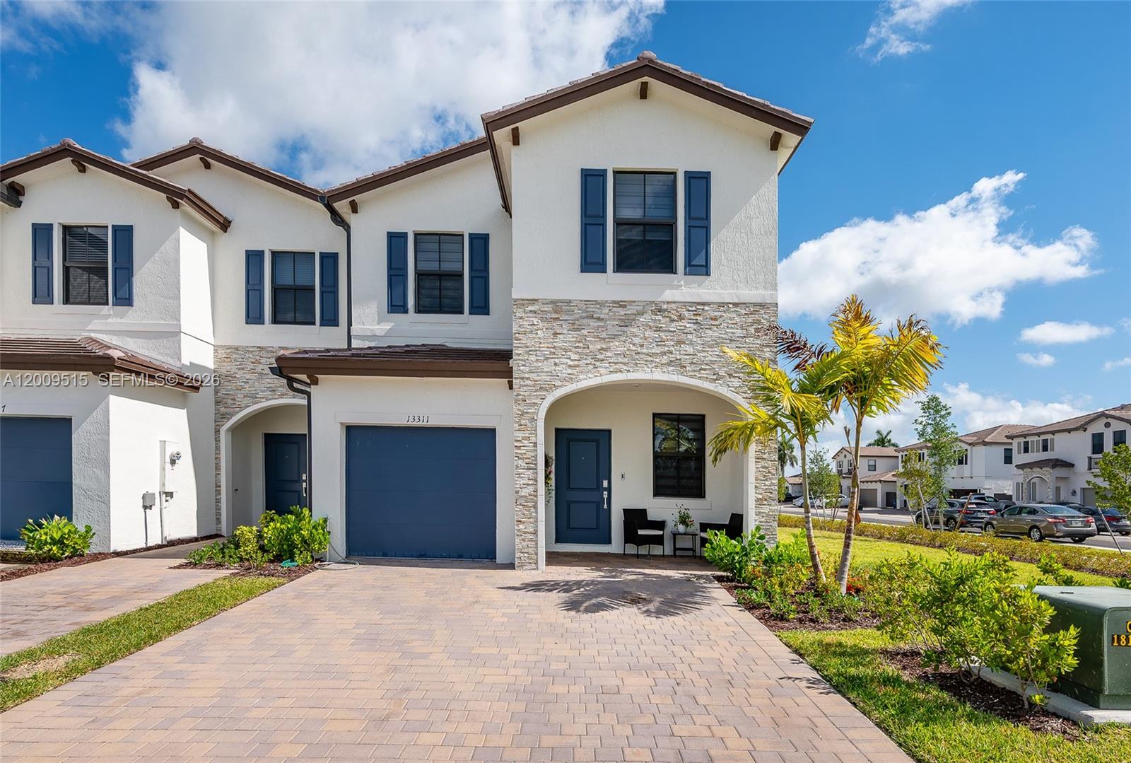13311 Southwest 233rd Terrace Homestead, FL 33032 - Photo 1 of 21 a front view of a house with yard and parking