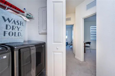 a view of a hallway with wooden shelves