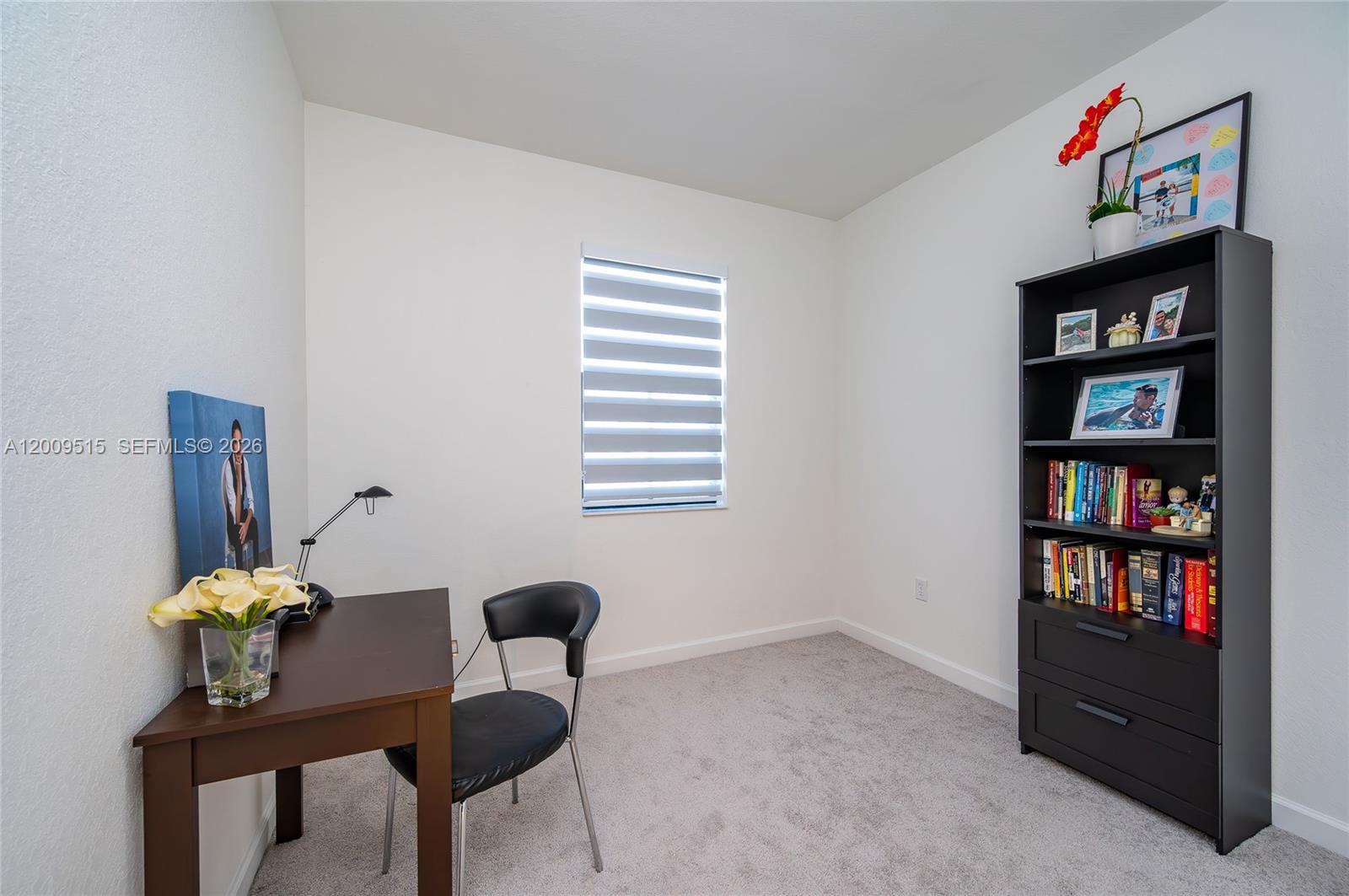 13311 Southwest 233rd Terrace Homestead, FL 33032 - Photo 17 of 21 a living room with furniture and a book shelf
