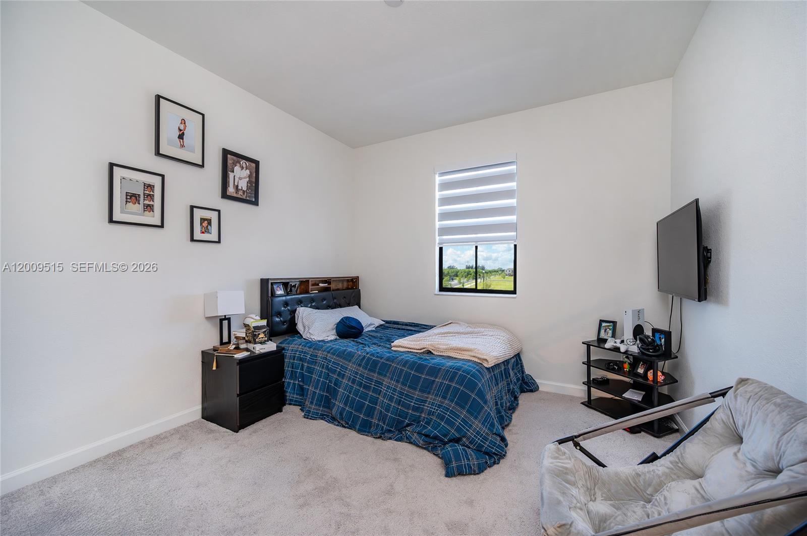 13311 Southwest 233rd Terrace Homestead, FL 33032 - Photo 18 of 21 a bedroom with bed and a flat screen tv