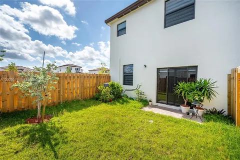 a view of a backyard with potted plants