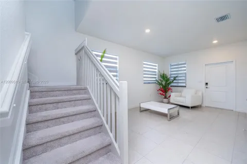 a view of hall with furniture and stairs