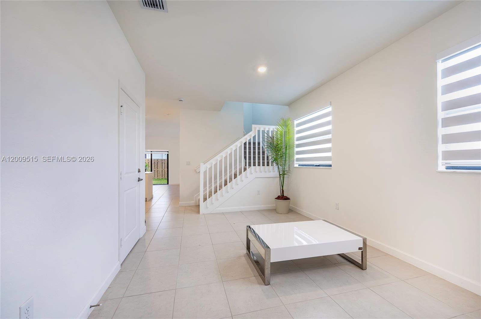 13311 Southwest 233rd Terrace Homestead, FL 33032 - Photo 5 of 21 a hallway with a wooden floor and a potted plant