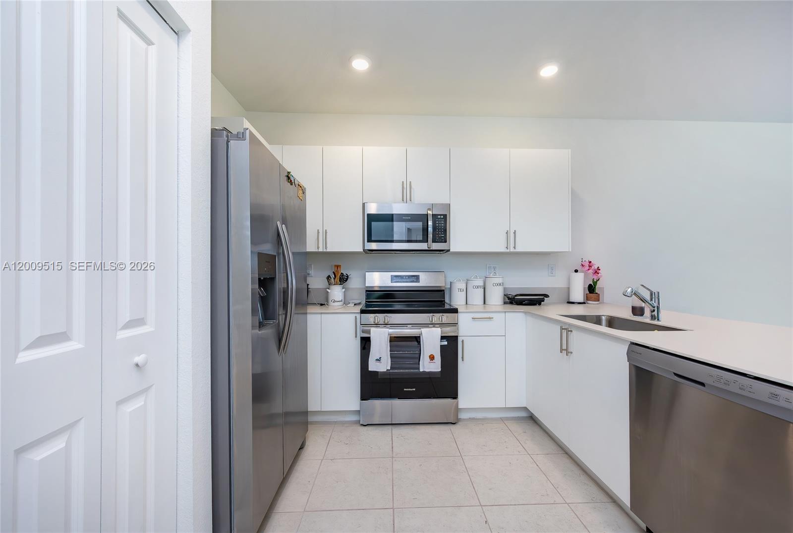 13311 Southwest 233rd Terrace Homestead, FL 33032 - Photo 7 of 21 a kitchen with stainless steel appliances granite countertop a stove top oven a sink and dishwasher