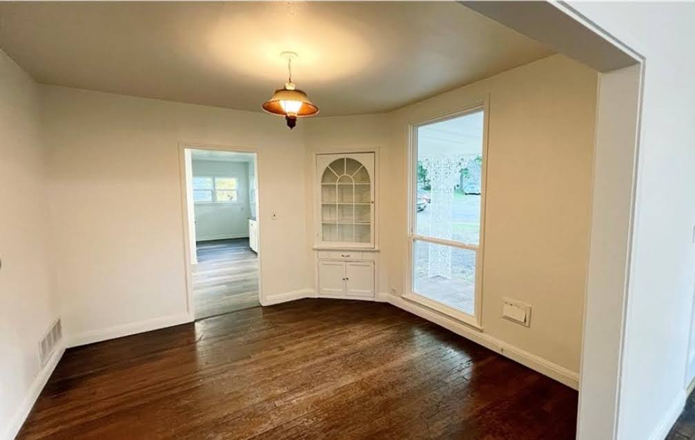 809 North 8th Street Temple, TX 76501 - Photo 8 of 20 Rich hardwood flooring graces this inviting living space, complete with a charming built-in cabinet.