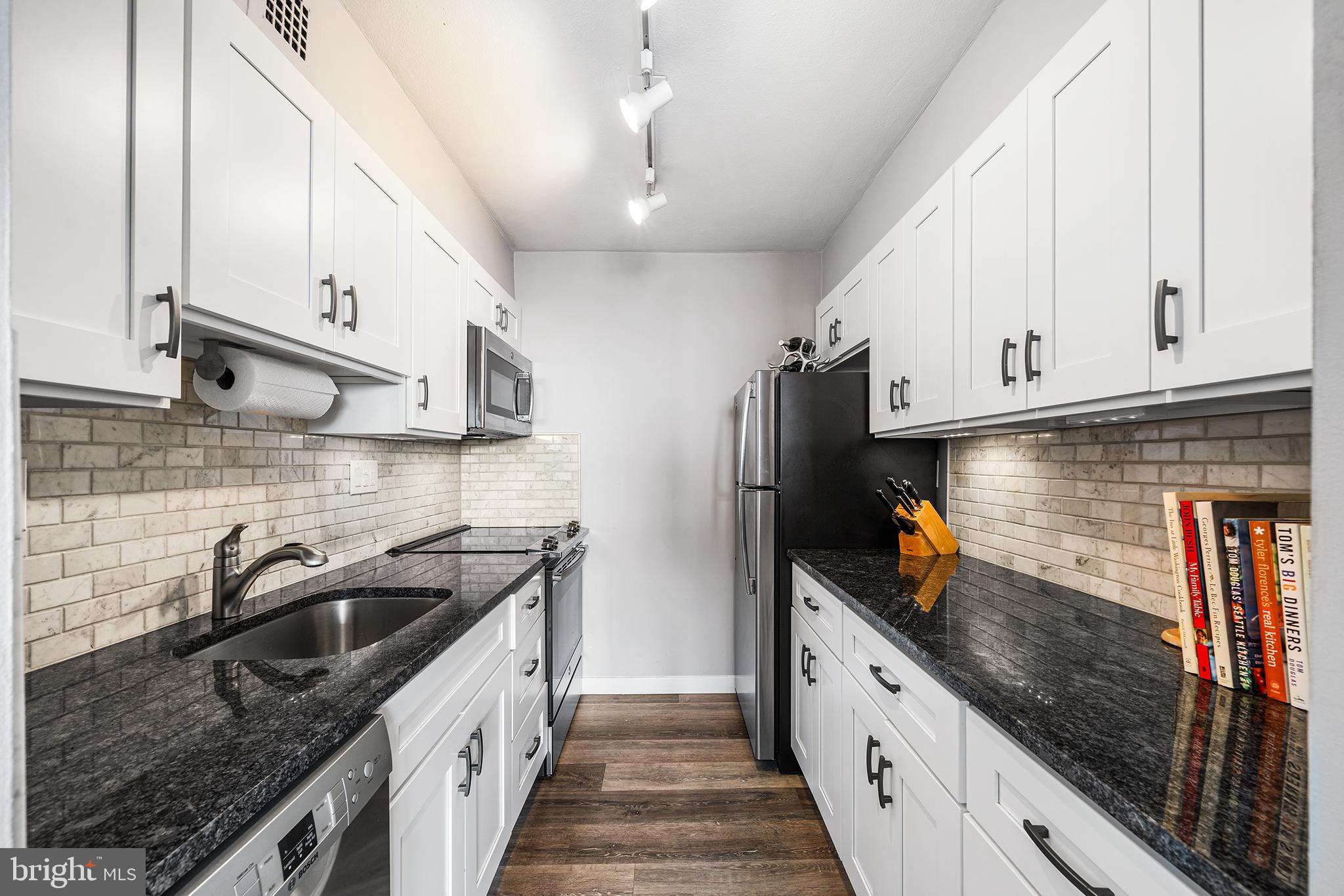 226-30 West Rittenhouse Square, Unit 2308 Philadelphia, PA 19103 - Photo 19 of 30 a kitchen with stainless steel appliances granite countertop a sink a stove and a refrigerator