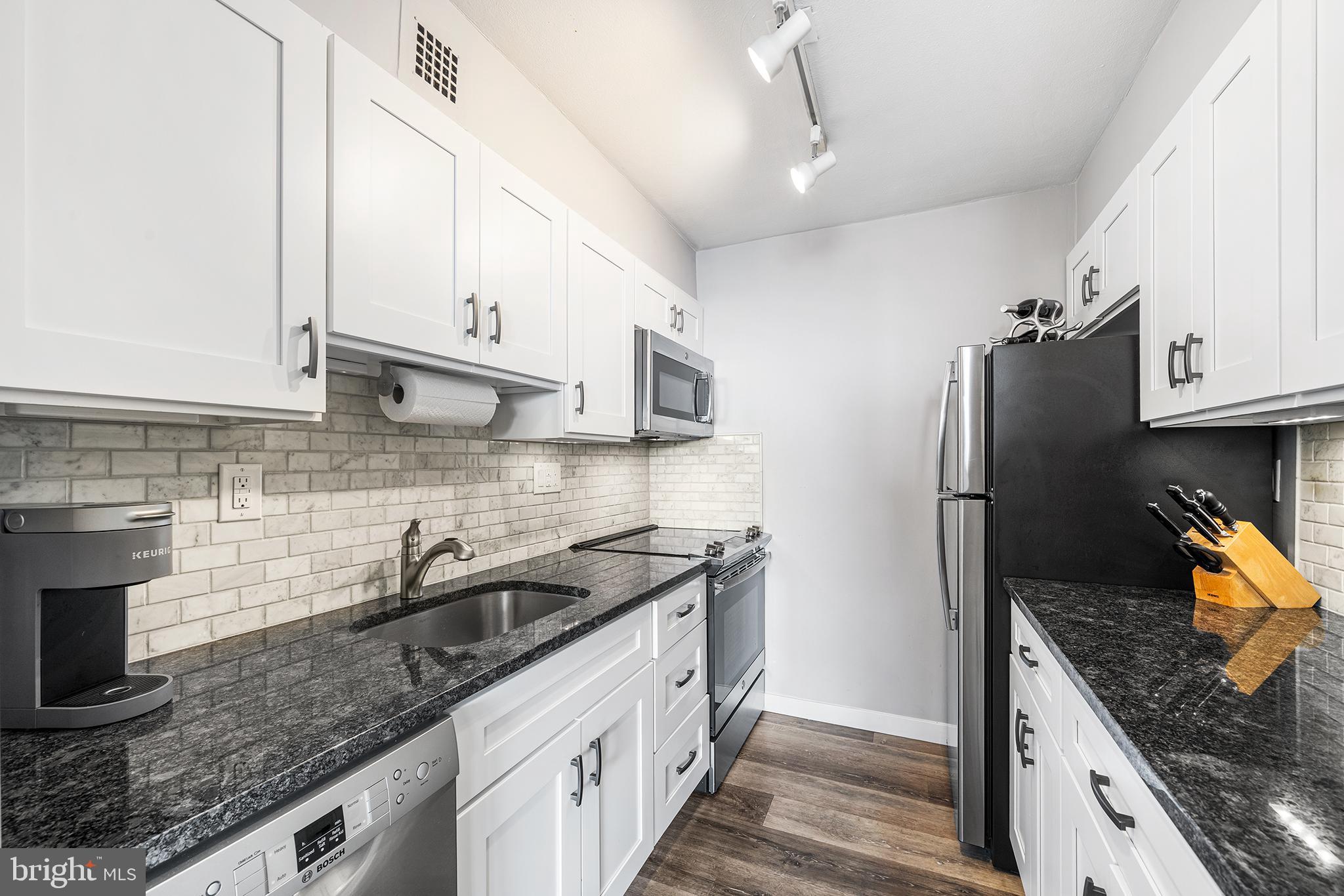 226-30 West Rittenhouse Square, Unit 2308 Philadelphia, PA 19103 - Photo 20 of 30 a kitchen with stainless steel appliances granite countertop a sink a stove and a refrigerator
