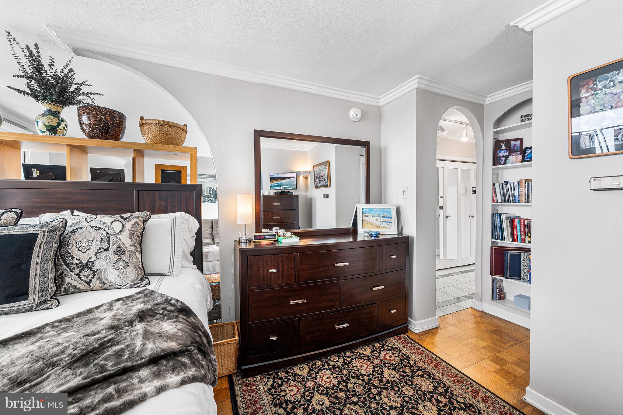 226-30 West Rittenhouse Square, Unit 2308 Philadelphia, PA 19103 - Photo 22 of 30 a bedroom with a bed and a mirror