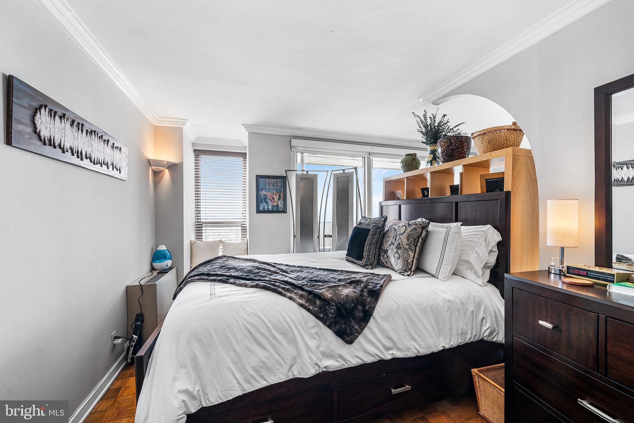 226-30 West Rittenhouse Square, Unit 2308 Philadelphia, PA 19103 - Photo 23 of 30 a bedroom with a large bed and a chandelier