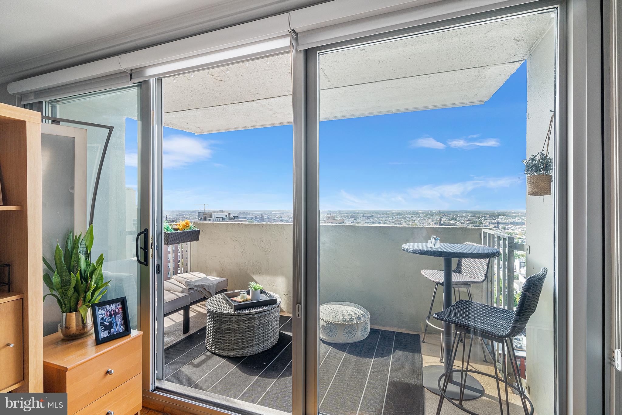 226-30 West Rittenhouse Square, Unit 2308 Philadelphia, PA 19103 - Photo 8 of 30 a view of a balcony and chairs potted plants with floor to ceiling window