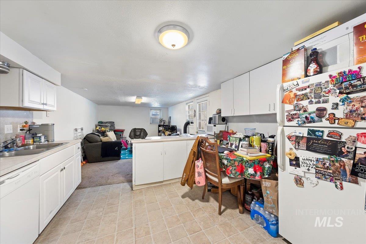 2209 West Idaho Street Boise, ID 83702 - Photo 42 of 42 Kitchen featuring white appliances, open floor plan, white cabinets