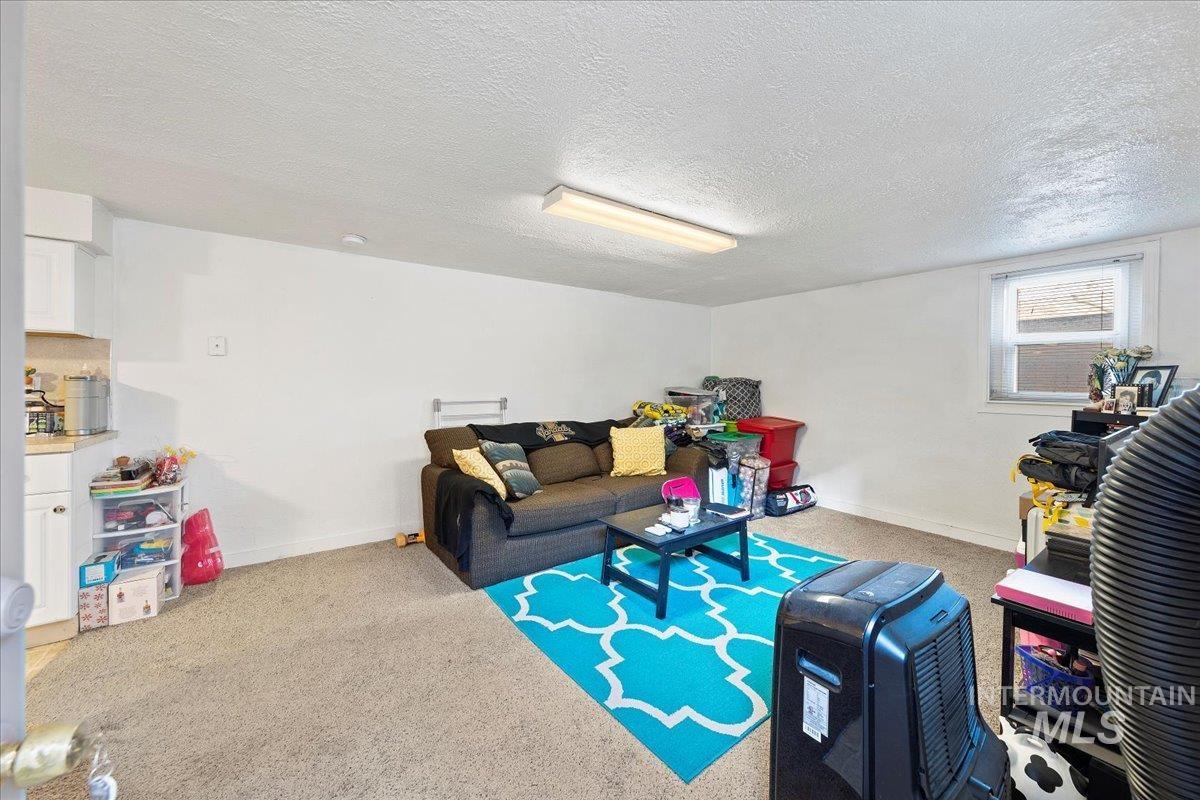 2209 West Idaho Street Boise, ID 83702 - Photo 33 of 42 Living area with carpet flooring