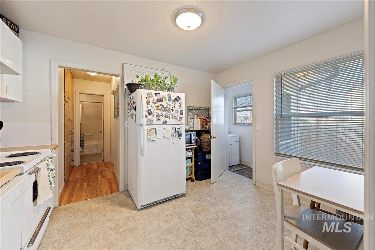 2209 West Idaho Street Boise, ID 83702 - Photo 7 of 42 Kitchen with white appliances, washer / dryer, and white cabinets