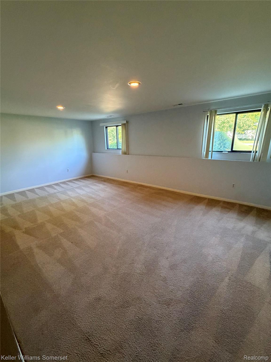 3277 Eastern Avenue Rochester, MI 48307 - Photo 10 of 13 Spacious room featuring neutral carpeting, recessed ceiling lighting, light-toned wall finishes, and two windows providing natural illumination