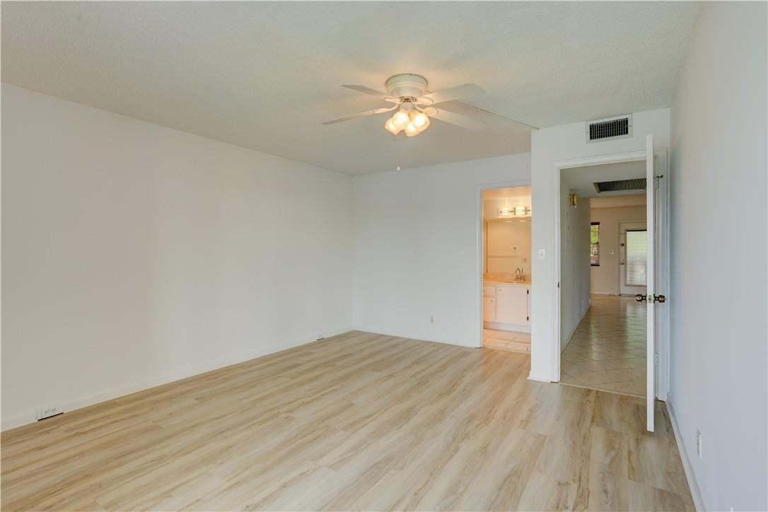 1903 Bermuda Circle, Unit E2 Coconut Creek, FL 33066 - Photo 15 of 25 wooden floor in an empty room