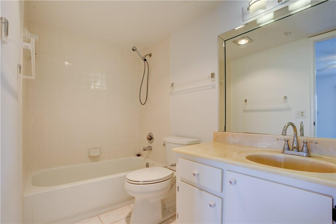 1903 Bermuda Circle, Unit E2 Coconut Creek, FL 33066 - Photo 17 of 25 a bathroom with a sink a toilet and shower