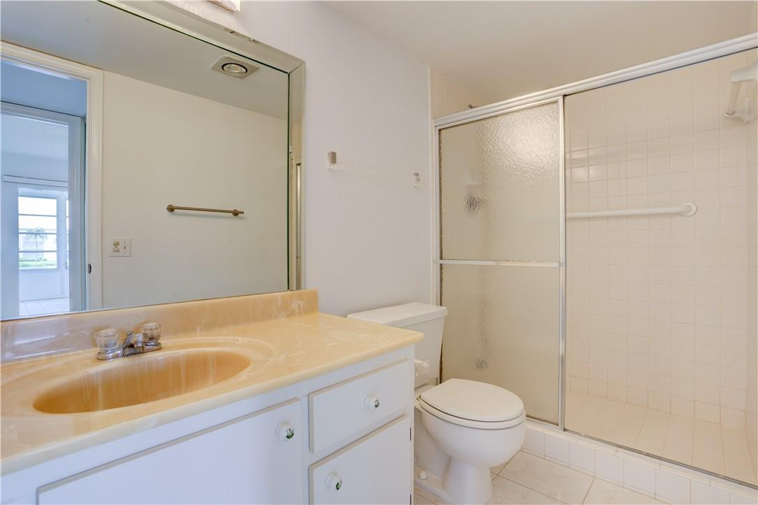 1903 Bermuda Circle, Unit E2 Coconut Creek, FL 33066 - Photo 18 of 25 a bathroom with a sink toilet and shower
