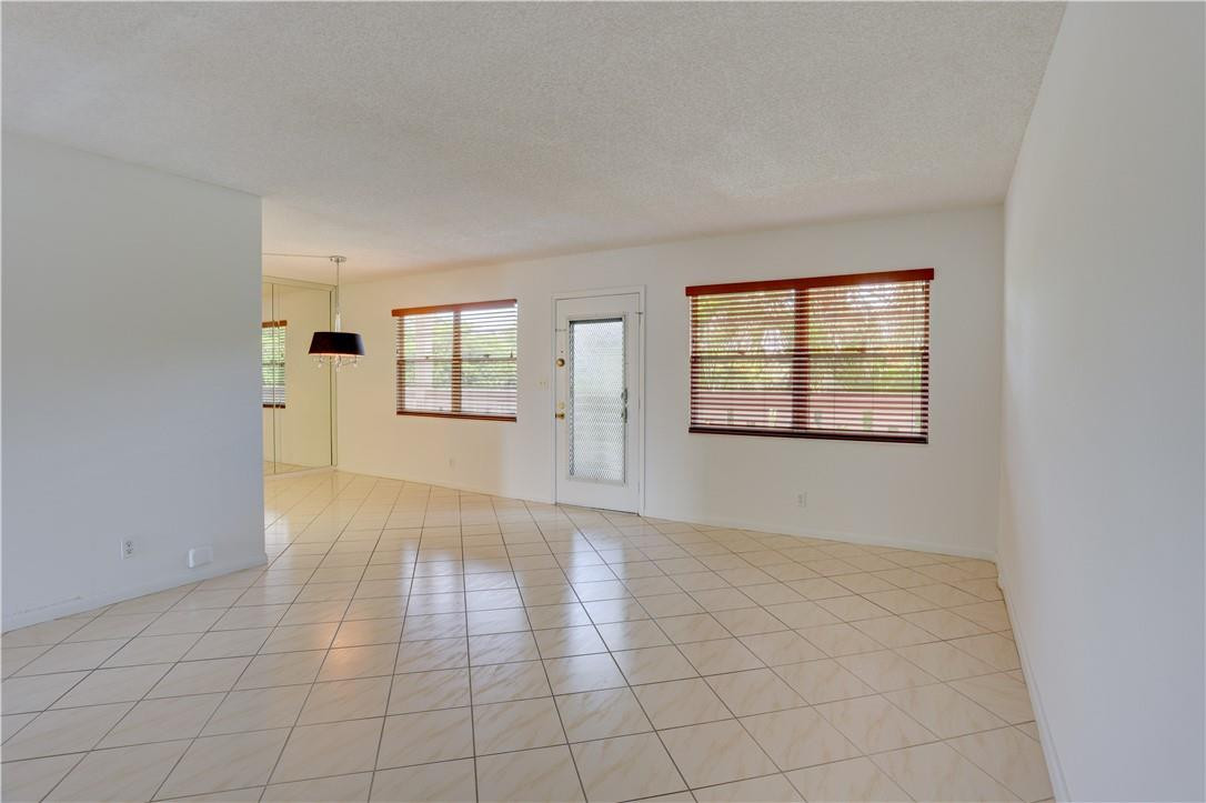 1903 Bermuda Circle, Unit E2 Coconut Creek, FL 33066 - Photo 4 of 25 an empty room with windows and closet