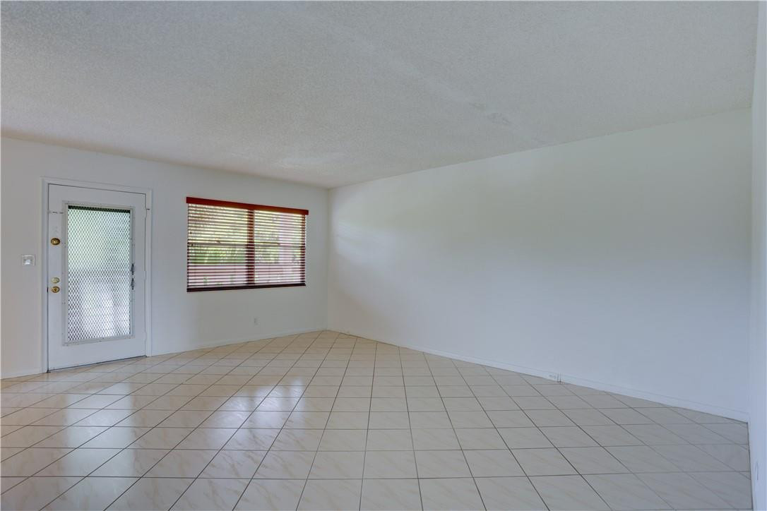 1903 Bermuda Circle, Unit E2 Coconut Creek, FL 33066 - Photo 5 of 25 an empty room with windows