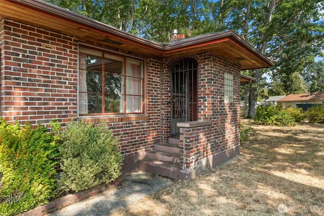 a yellow house with trees in front of it