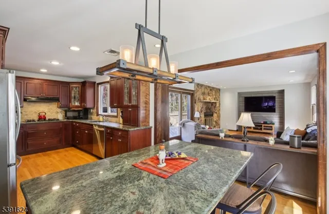 a kitchen with stainless steel appliances granite countertop sink stove and refrigerator