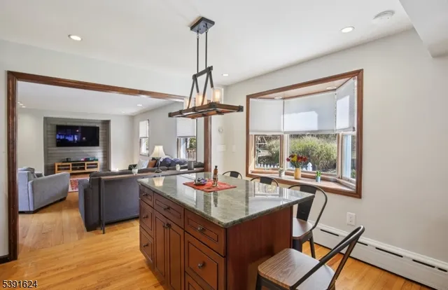 a kitchen with a stove and a wooden floor
