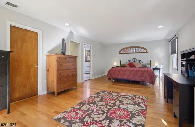 a view of a bedroom with furniture and window