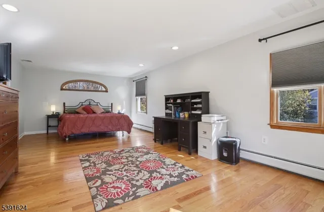 a bedroom with furniture and a window