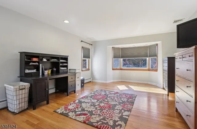 a living room with furniture and flat screen tv