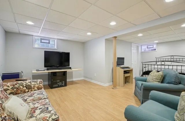 a bedroom with furniture and a flat screen tv