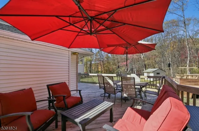 a view of a outdoor sitting area with furniture and umbrella