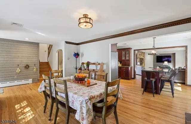 a dining room with furniture and wooden floor