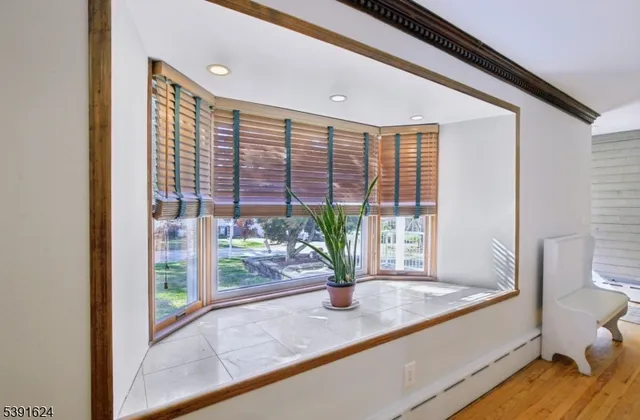 a view of living room with a floor to ceiling window and wooden floor