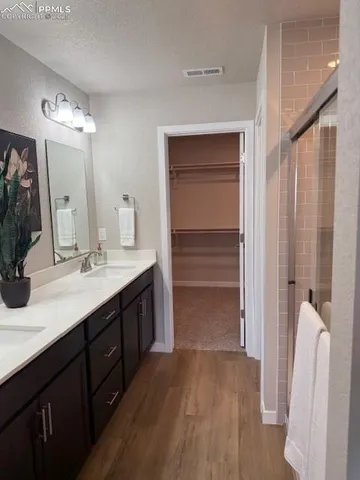 a bathroom with a double vanity sink a and a mirror