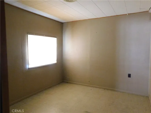an empty room with a wooden door