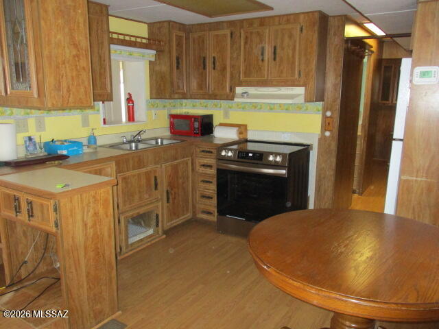3100 South Kinney Road, Unit 193 Tucson, AZ 85713 - Photo 8 of 35 a kitchen with stainless steel appliances a stove a refrigerator a sink a stove and dishwasher