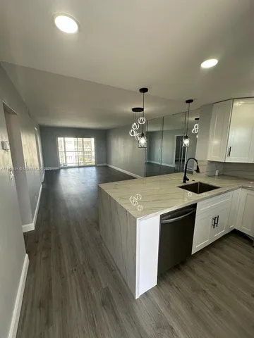 a view of a kitchen counter space and wooden floor