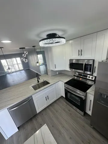 a kitchen with granite countertop a stove and a sink