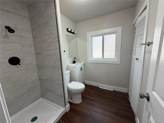 a bathroom with a toilet and a shower