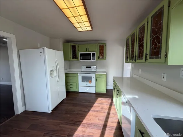 a kitchen with a refrigerator and a sink