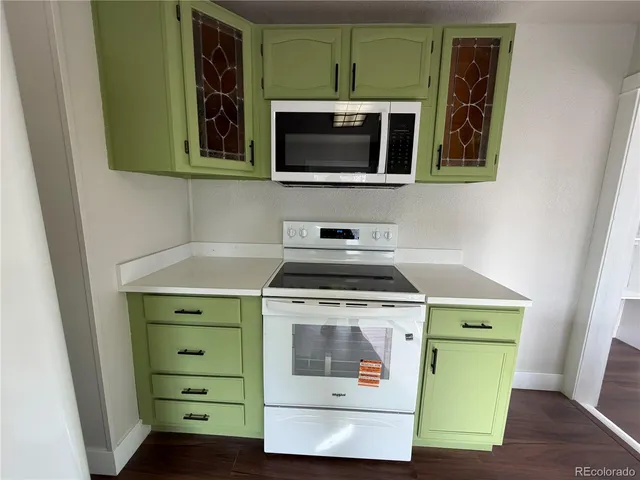 a kitchen with a stove and a microwave