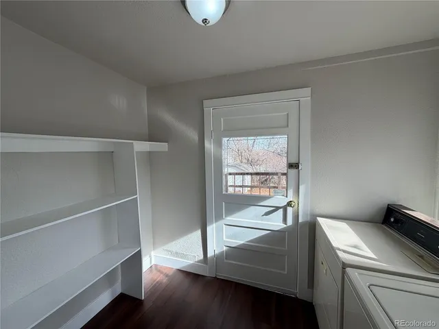 a room with wooden floor and a window