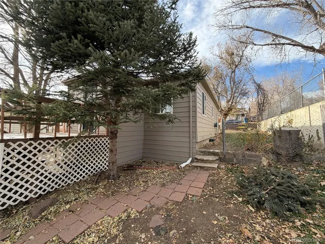 a view of a brick house with a large tree