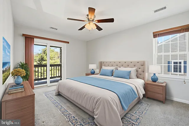 a bedroom with a large bed and windows