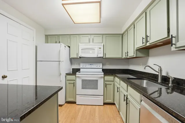 a kitchen with a sink a stove and refrigerator