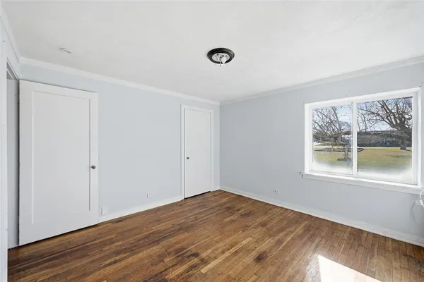 a view of a room with wooden floor and windows