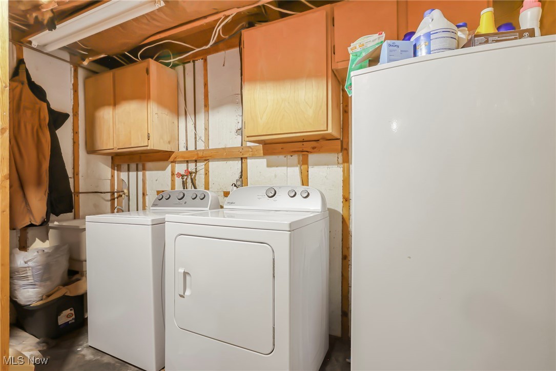 232 McGill Road Vincent, OH 45784 - Photo 27 of 49 Laundry room with concrete floors, cabinet space, and independent washer and dryer