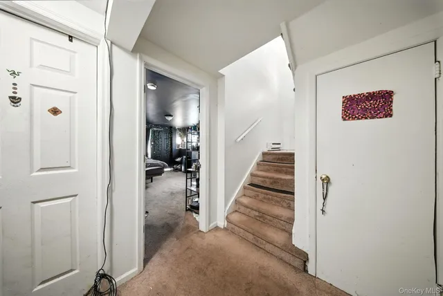 a view of a hallway with wooden floor and entryway