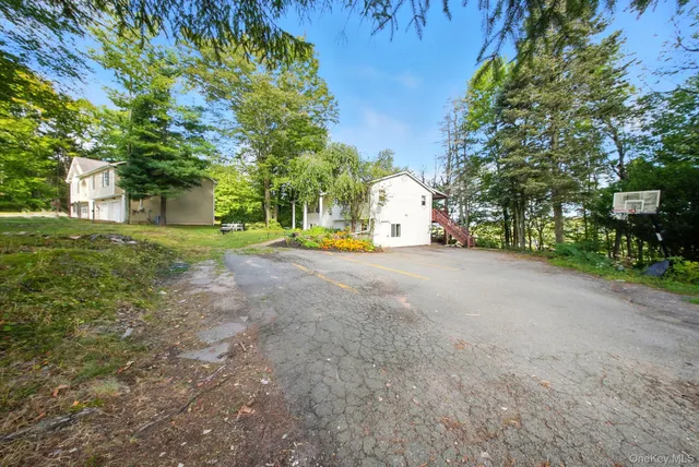 a view of a house with a yard and tree